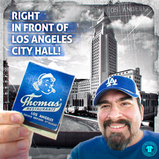 Turi holding a Thomas Restaurant matchbook in front of Los Angeles City Hall